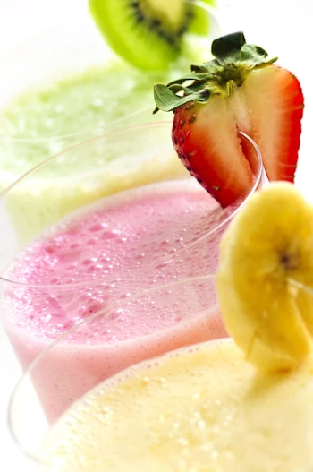 3 smoothies with fruit garnishes