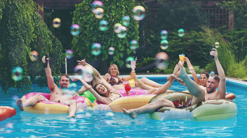adults playing with bubbles in the swimming pool