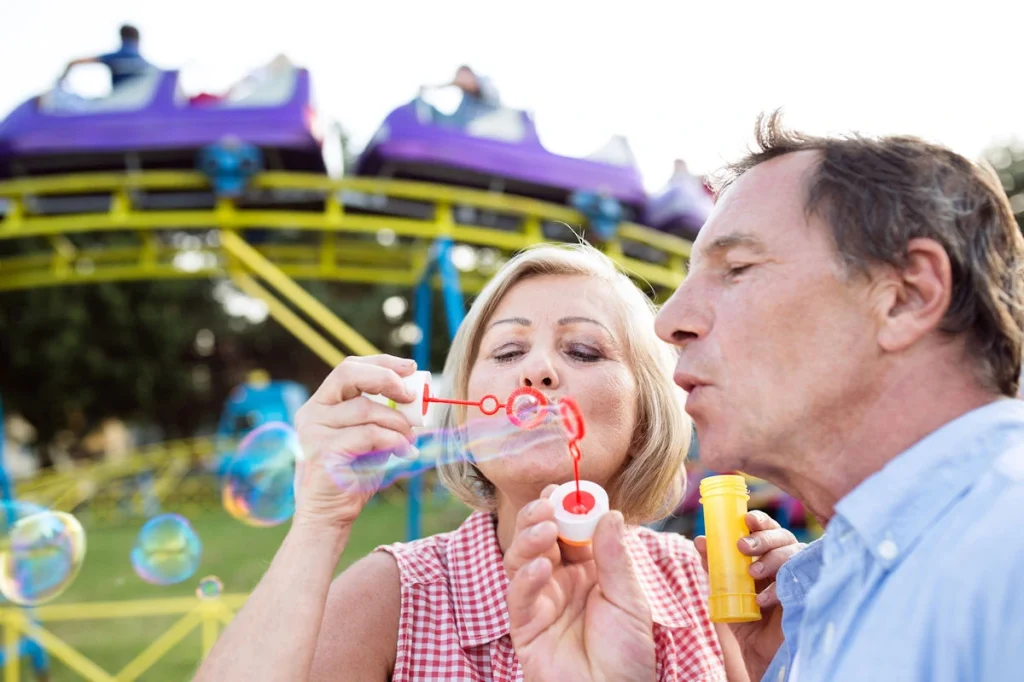 blow bubbles while waiting in line at theme park