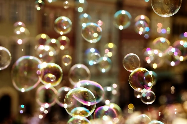 impromptu play blowing bubbles in the wind in city